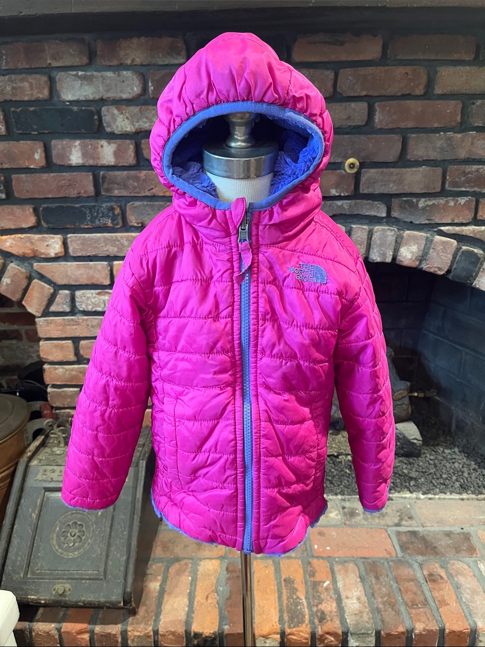 The North Face Kids Pink Hooded Reversible Puffer Jacket with fuzzy purple side